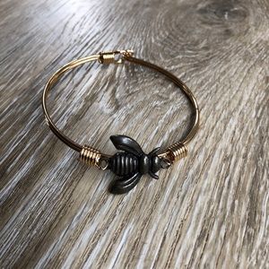 Gold color bangle bracelet with a black honey bee